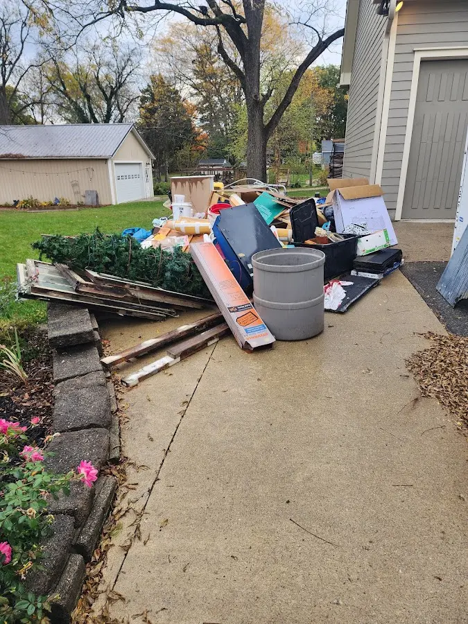 Dumpster being loaded with debris for Commercial Dumpster Rental in Casco